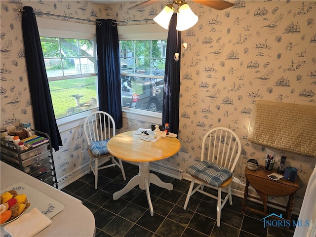 dining room featuring dark tile patterned floors and ceiling fan