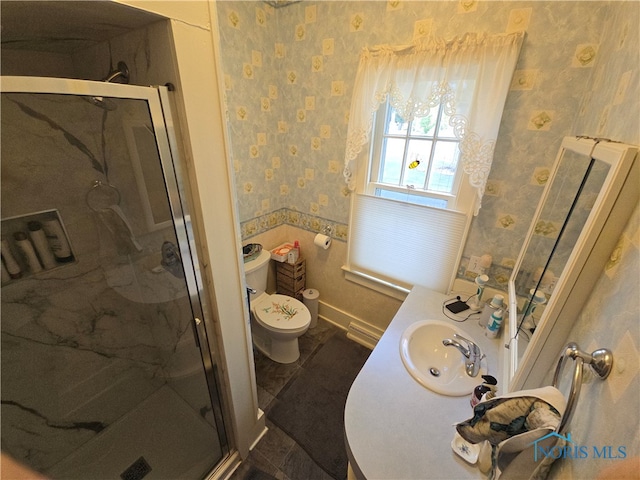 bathroom with walk in shower, vanity, and toilet