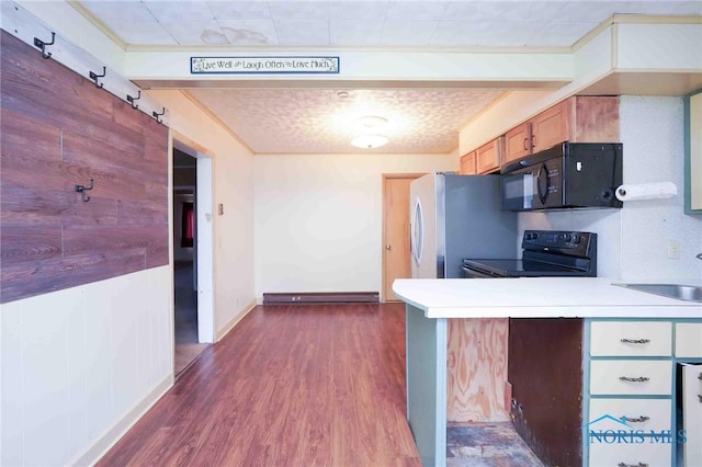 kitchen featuring black appliances, dark wood-type flooring, and sink