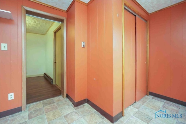 hallway with wood-type flooring and wooden walls