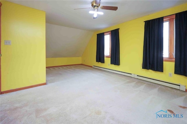 bonus room featuring light carpet, a baseboard radiator, plenty of natural light, and vaulted ceiling