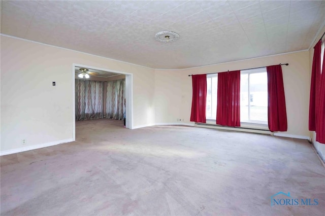 carpeted empty room with ceiling fan and a baseboard radiator