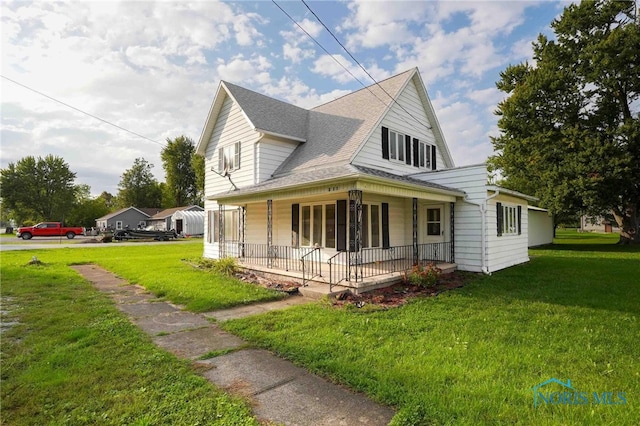 view of home's exterior with a yard and covered porch