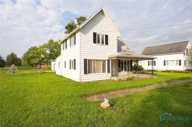 rear view of house with a yard