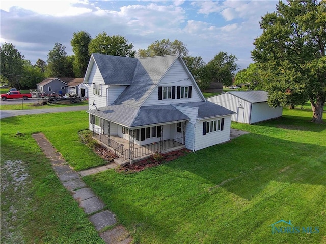 rear view of property featuring a porch and a lawn