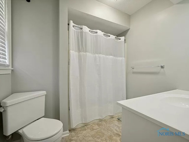 bathroom featuring vanity, toilet, and a shower with shower curtain