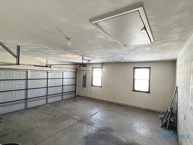 garage featuring electric panel and a garage door opener