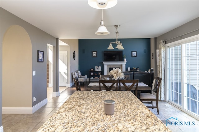 tiled dining space with a fireplace