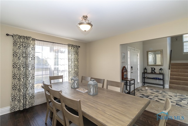 dining room featuring plenty of natural light and dark wood-type flooring