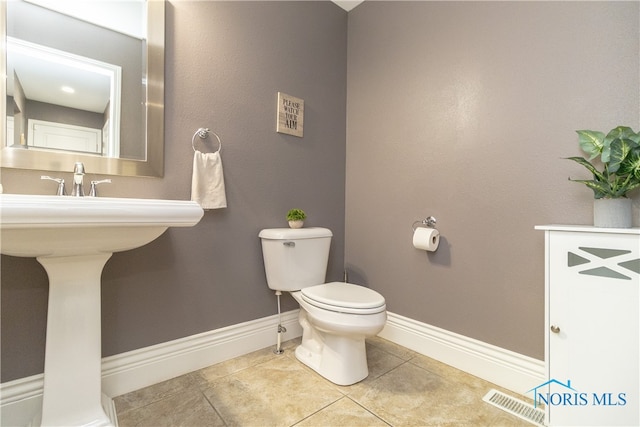 bathroom featuring tile patterned flooring and toilet