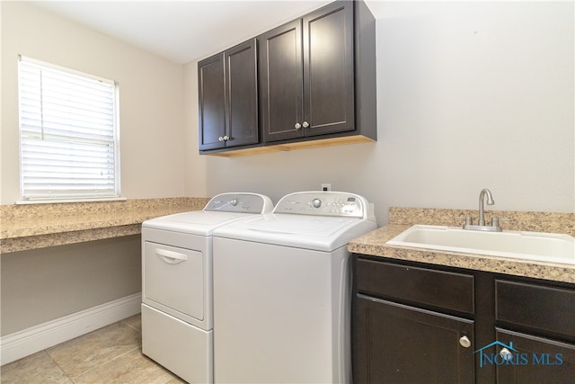 laundry area with cabinets, sink, independent washer and dryer, and light tile patterned flooring