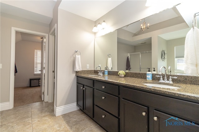 bathroom featuring vanity, lofted ceiling, tile patterned flooring, and an enclosed shower