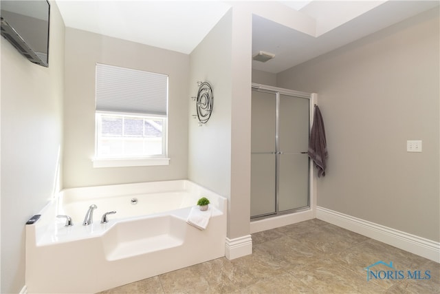 bathroom with separate shower and tub