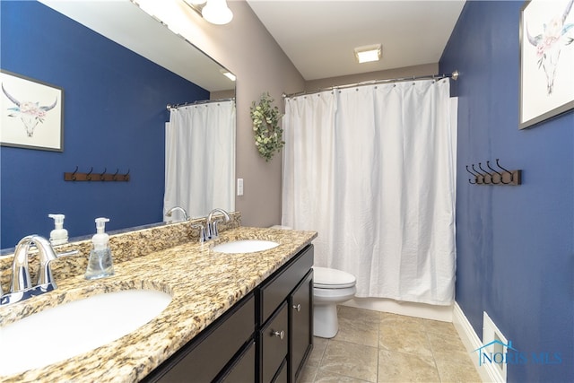 bathroom with vanity, tile patterned flooring, toilet, and curtained shower