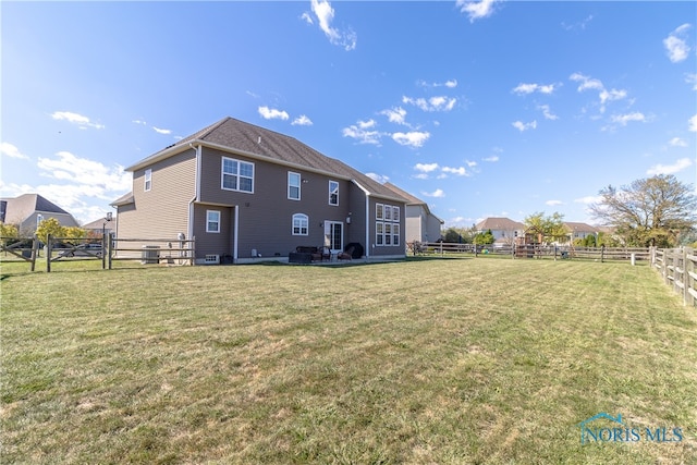 rear view of property with a lawn