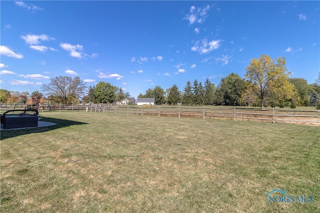 view of yard with a rural view