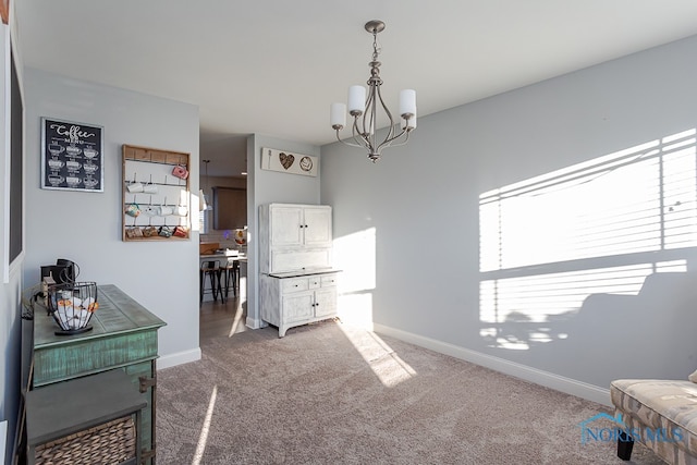 interior space featuring carpet floors and an inviting chandelier