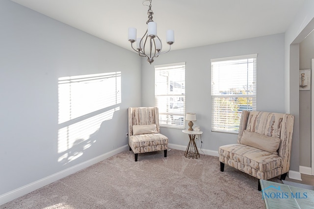 sitting room featuring an inviting chandelier and carpet flooring