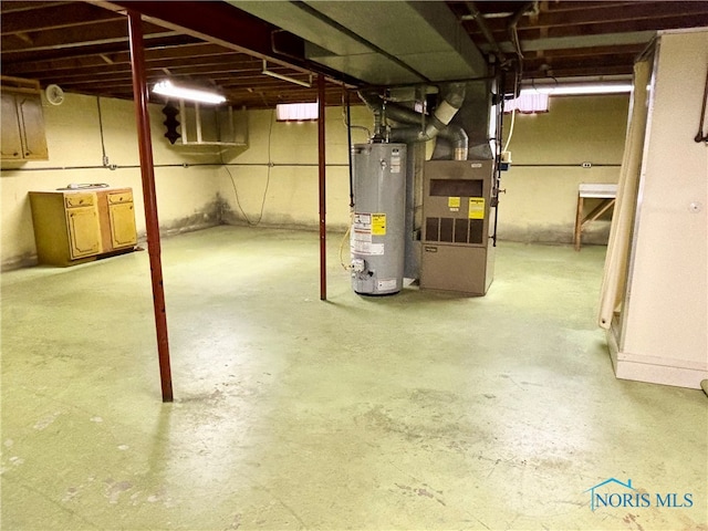 basement featuring gas water heater and heating unit