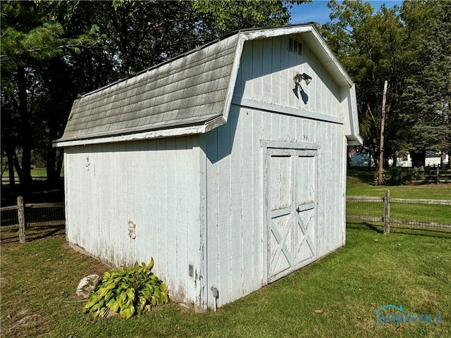 view of outdoor structure featuring a lawn