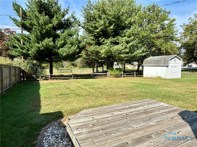 view of yard with a storage shed and a wooden deck