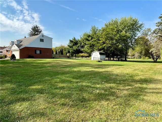 view of yard with a garage and a storage unit