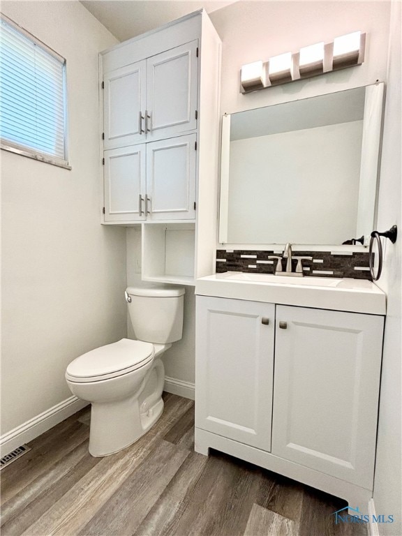 bathroom featuring vanity, hardwood / wood-style floors, and toilet