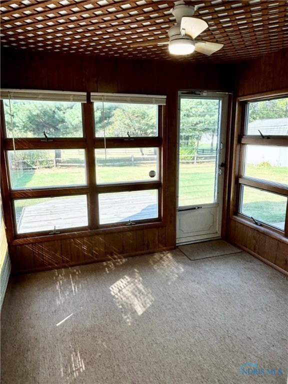 unfurnished sunroom with ceiling fan