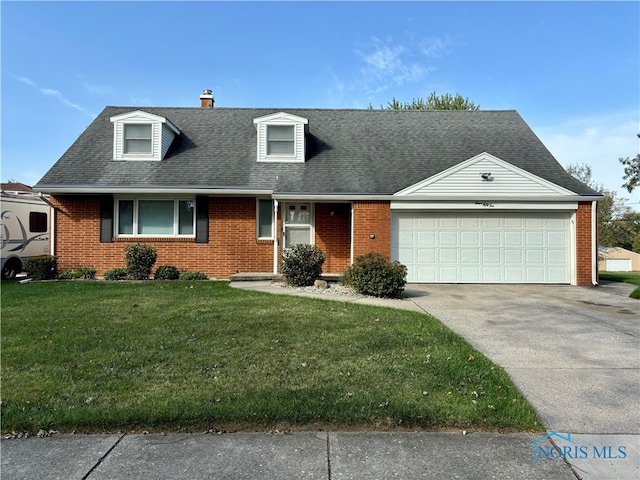 view of front of property featuring a garage and a front lawn