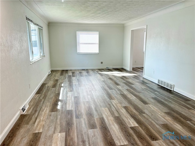 unfurnished room featuring hardwood / wood-style floors and plenty of natural light