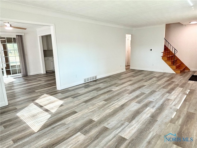 spare room featuring a textured ceiling, ornamental molding, ceiling fan, and hardwood / wood-style flooring