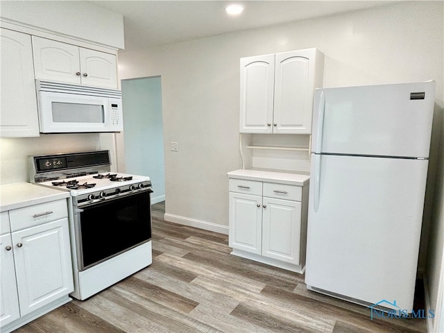 kitchen featuring light hardwood / wood-style flooring, white appliances, and white cabinetry