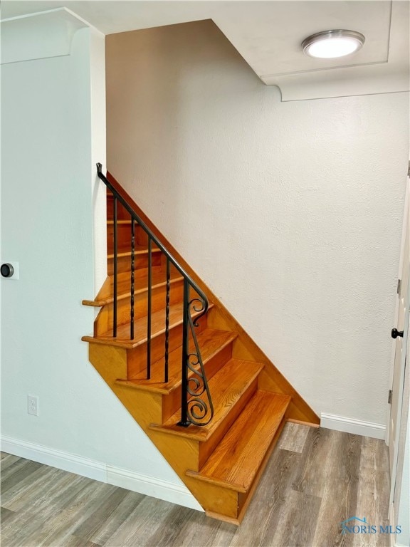 staircase featuring hardwood / wood-style floors