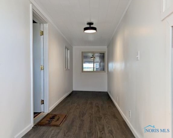 hall featuring crown molding and dark wood-type flooring