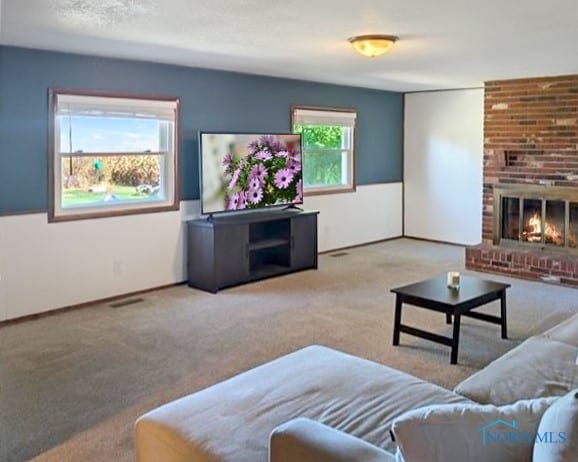 living room with light carpet and a brick fireplace