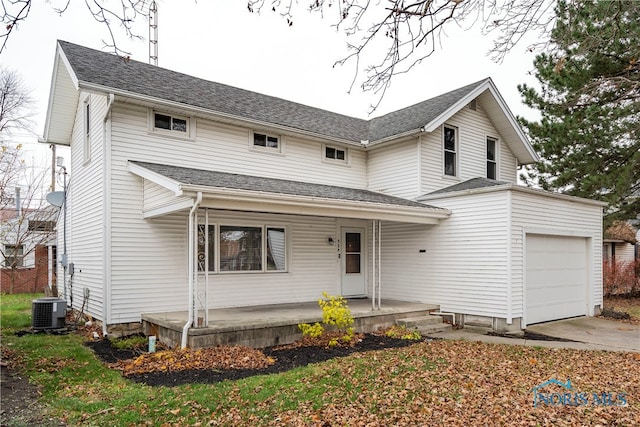 view of front facade with a porch, central AC, and a garage