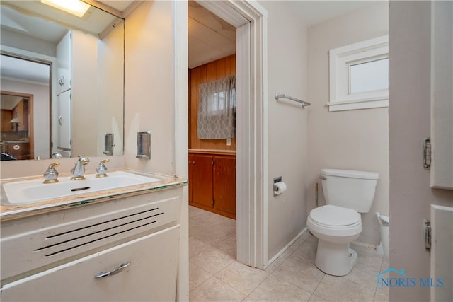 bathroom with tile patterned flooring, vanity, and toilet