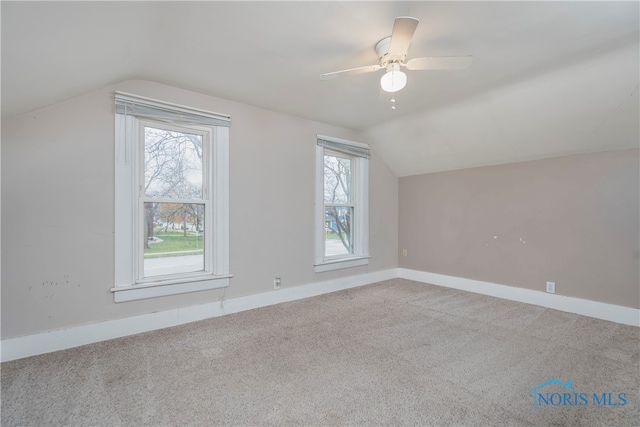 bonus room with a wealth of natural light, ceiling fan, light colored carpet, and lofted ceiling