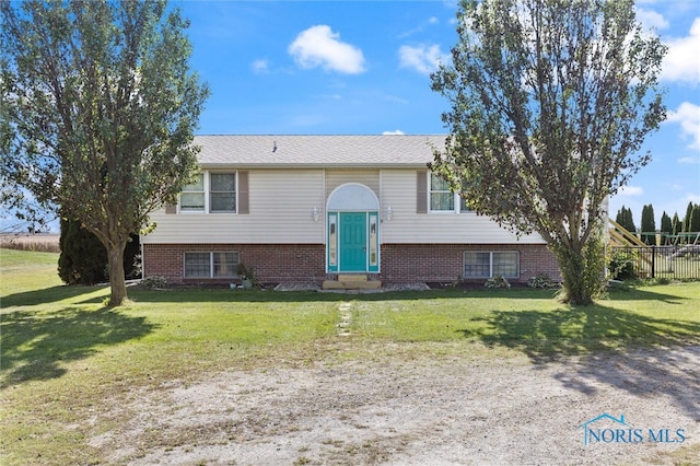 raised ranch featuring a front yard