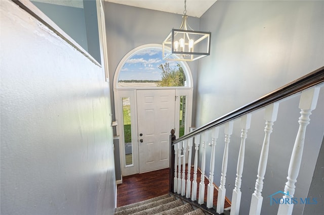 foyer featuring dark hardwood / wood-style floors and a chandelier