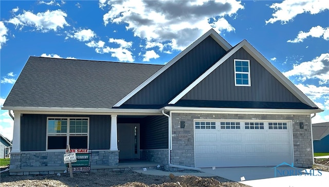 craftsman inspired home featuring a garage and a porch