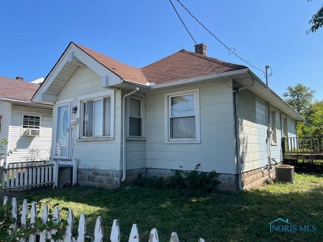 exterior space featuring a yard and central AC unit