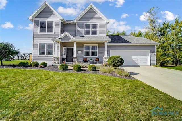 view of front of property featuring a garage, a porch, and a front yard