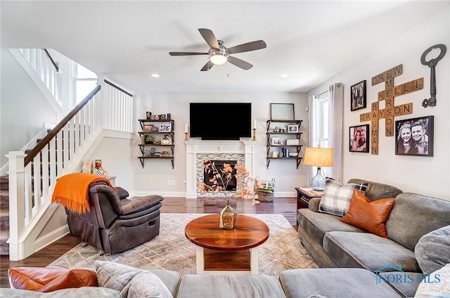 living room featuring ceiling fan and hardwood / wood-style flooring