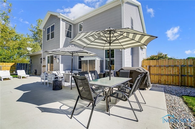 rear view of house with outdoor lounge area and a patio