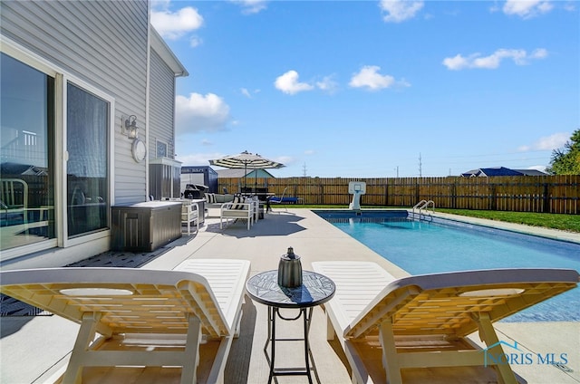 view of swimming pool with a patio