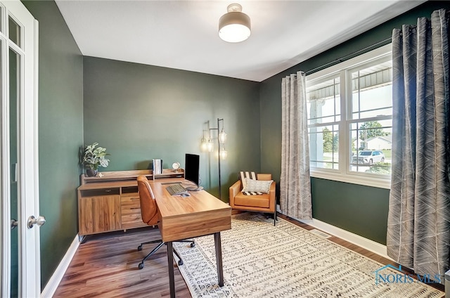 home office with hardwood / wood-style floors