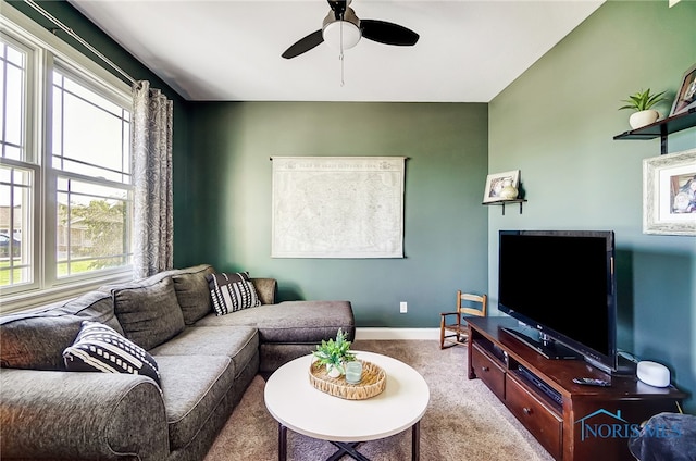 carpeted living room featuring ceiling fan and a wealth of natural light