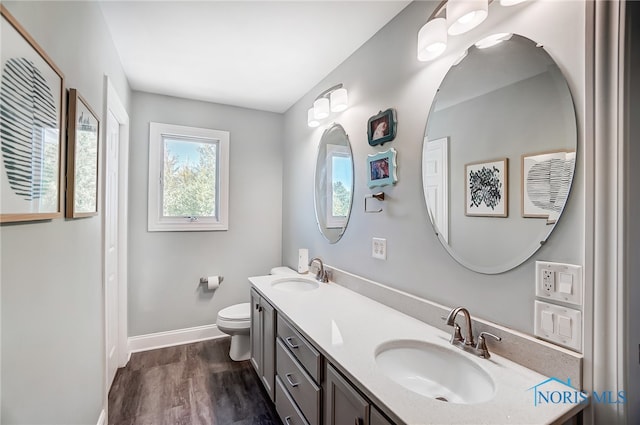 bathroom with vanity, hardwood / wood-style floors, and toilet