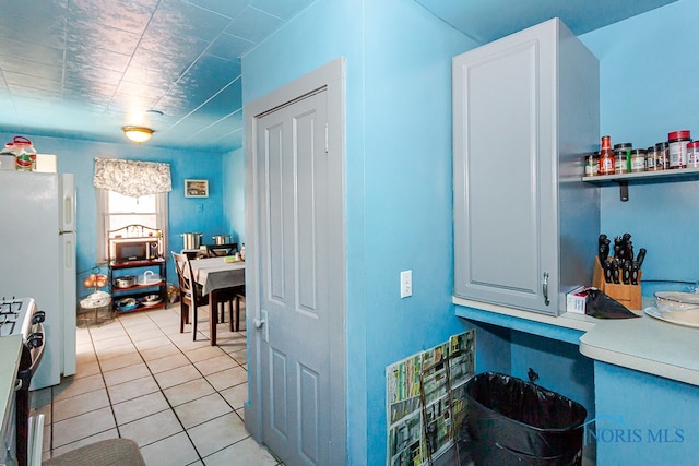 kitchen with light tile patterned flooring and appliances with stainless steel finishes